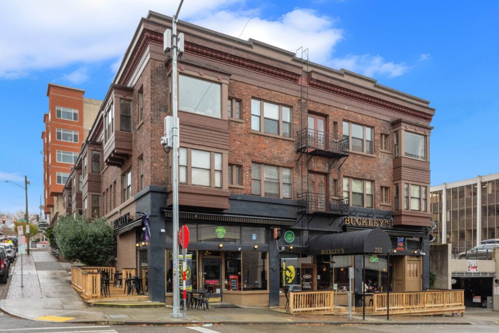 Exterior view of Buckley's building, old brick building with patio seating