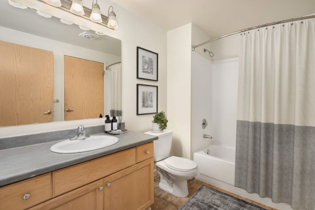Start your day in style in this modern bathroom with granite countertops and stainless steel fixtures.