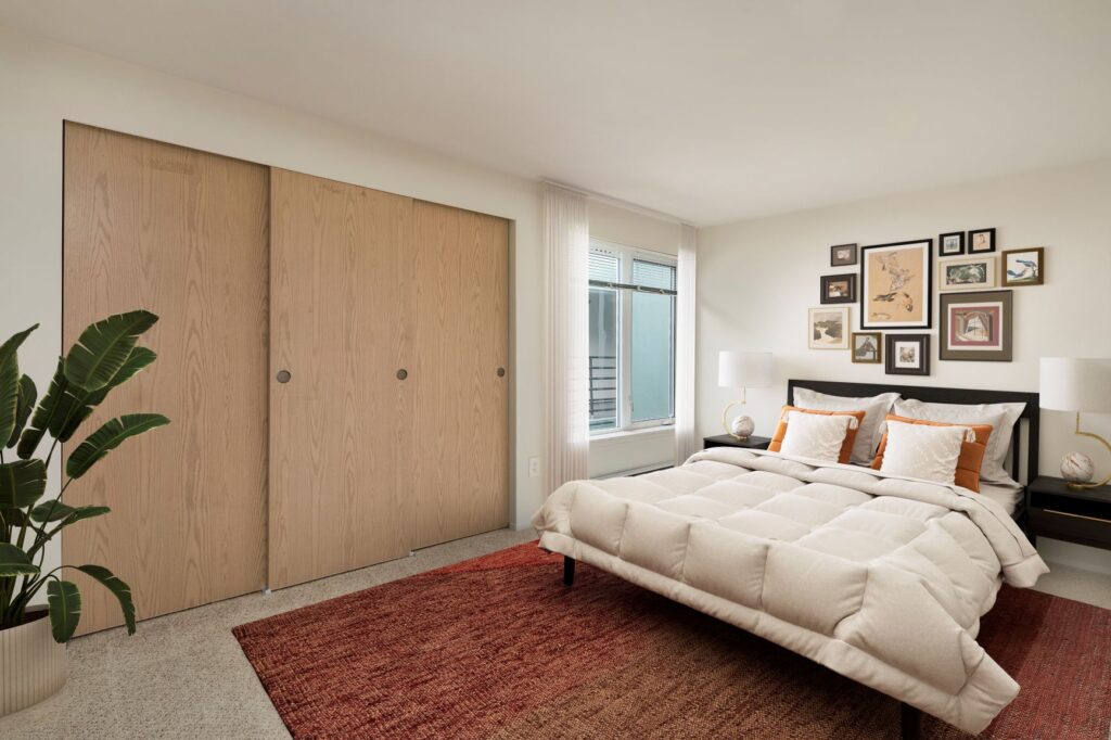 A relaxing bedroom with an inviting bed, a cozy rug, and a tranquil view.