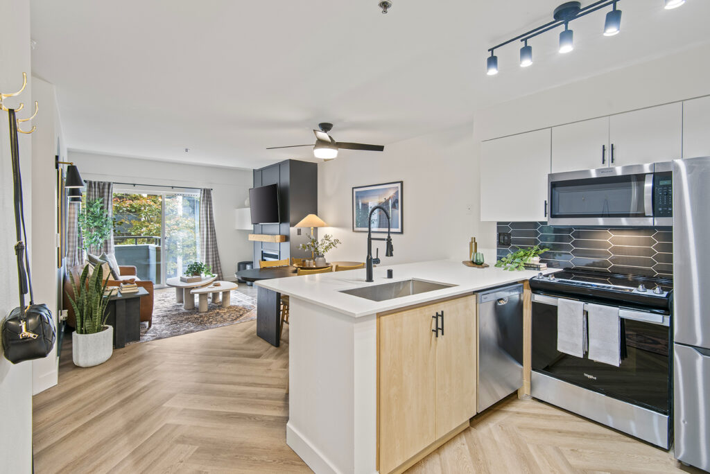 Kitchen with stainless steel appliances at Novi at Queen Anne apartments near Downtown Seattle
